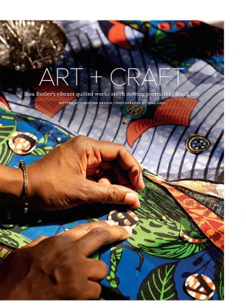 Close-up of hands sewing colorful patterned fabric with needle. Art and craft project featuring detail of stitching and textile work.