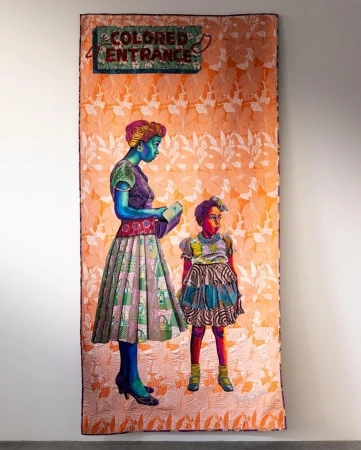 A mixed-media artwork on fabric features an African-American woman and child in a vintage style standing under a "Colored Entrance" sign.