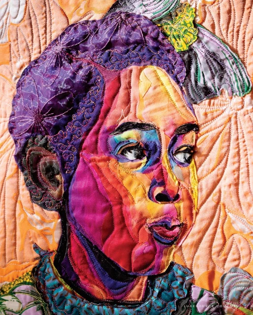 Artistic fabric portrait of a person with unique features, bright colors, and stitched textures, set against a quilted backdrop.