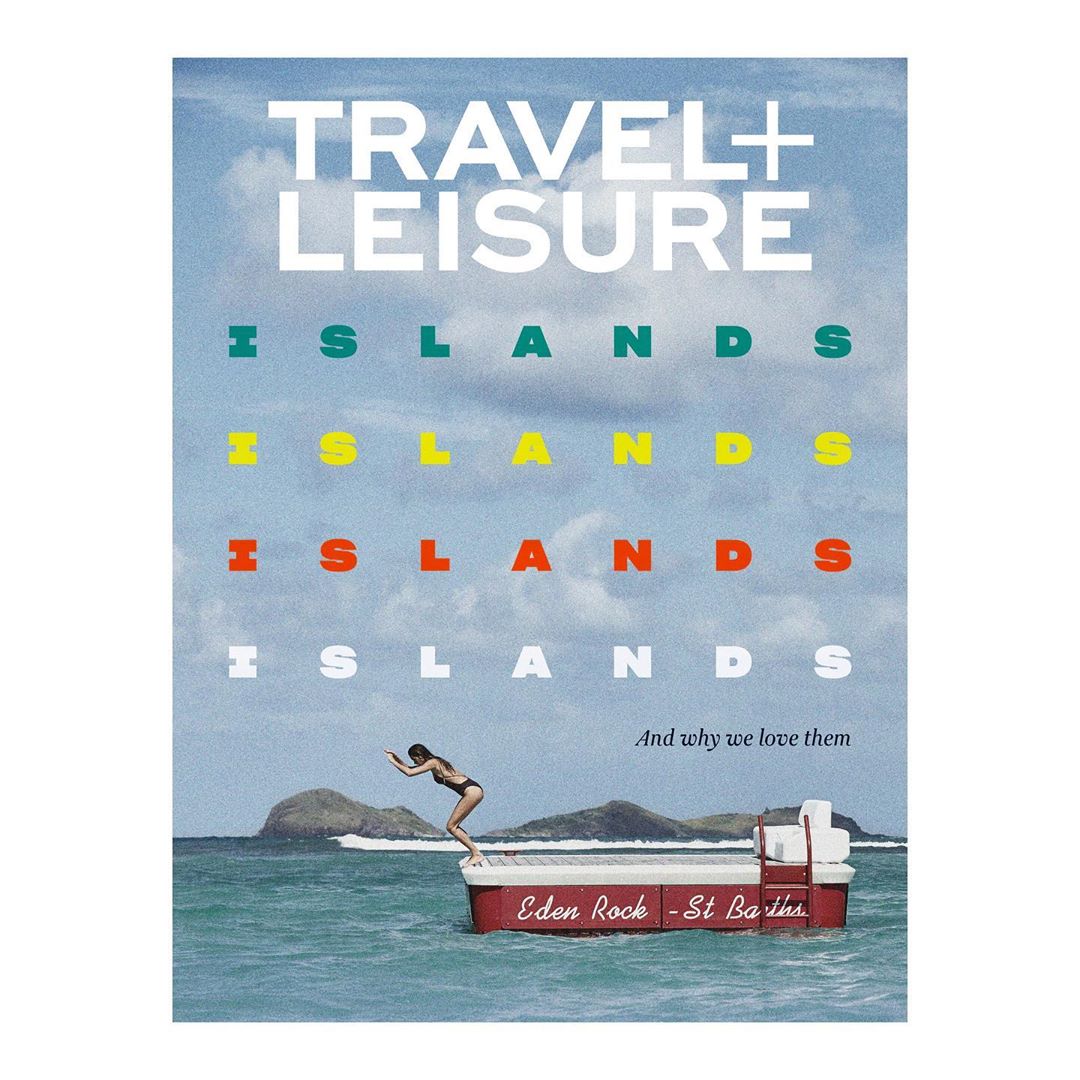 Travel magazine cover featuring a woman diving from a boat with the words TRAVEL + LEISURE, and ISLANDS stacked on a sky and sea background.