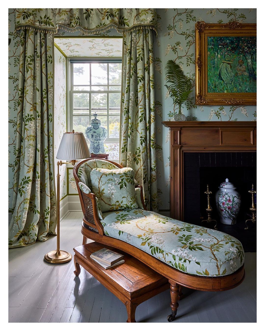 Luxurious sitting room interior with chaise lounge, patterned curtains, and botanical-print wallpaper creating a cozy, elegant ambiance.