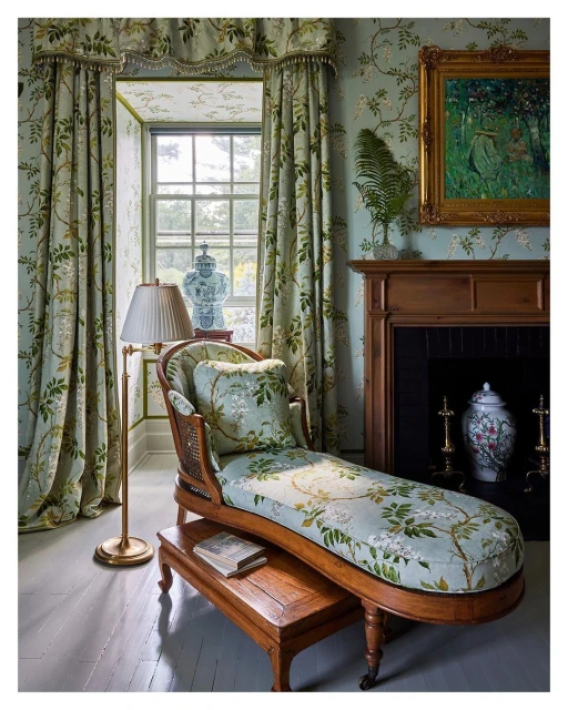 Luxurious sitting room interior with chaise lounge, patterned curtains, and botanical-print wallpaper creating a cozy, elegant ambiance.
