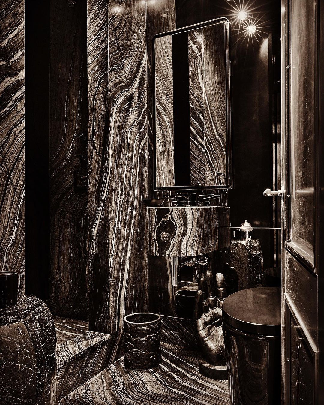 Luxurious bathroom interior featuring a sink, mirror, and various decor elements, all adorned with a distinctive wood-grain marble pattern.
