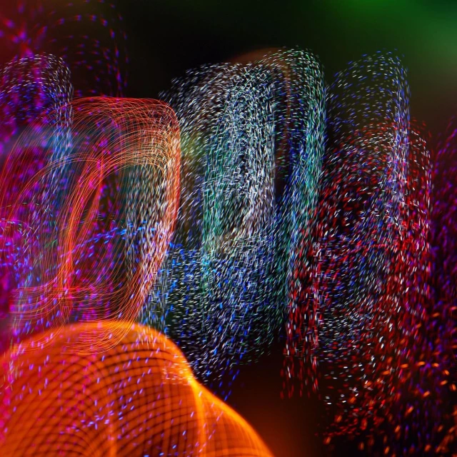 Abstract, blurred lights create a dynamic pattern with vibrant colors in an artistic, long-exposure photography. 