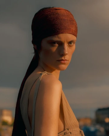 Portrait of a model wearing a rust-colored headscarf and a beige top in Paris by Noemi Ottilia Szabo.