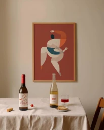 Framed illustration of an abstract dancing figure on a red background, displayed above a table with wine bottles and a glass