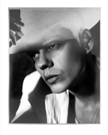 Monochrome portrait of a man wearing a cowboy hat, photographed by Norman Jean Roy in New York.