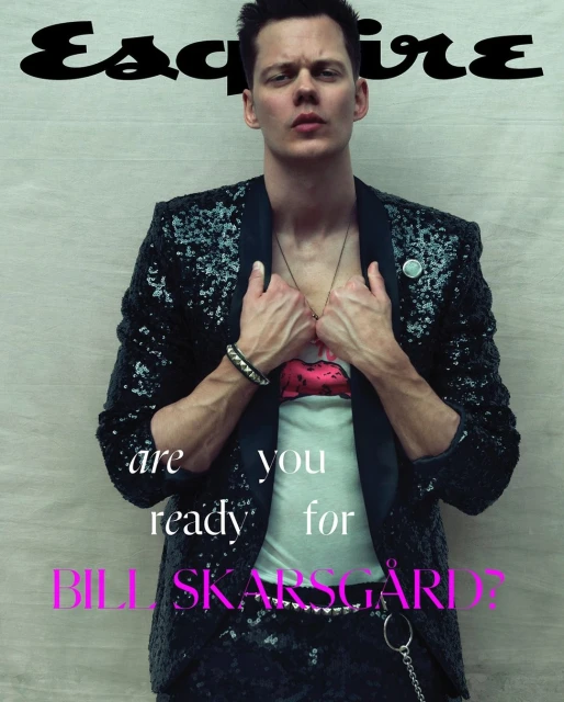 Esquire magazine cover featuring Bill Skarsgard in a sequined jacket, graphic tee, and black pants, standing indoors with logo text.