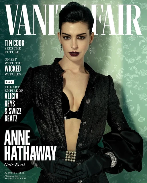 Vanity Fair cover featuring Anne Hathaway in a black jacket and bra, captured in a studio setting with floral wallpaper backdrop.