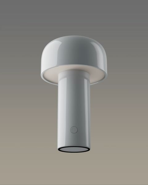 White mushroom table lamp with a glossy finish, cylindrical base and rounded top on a gradient gray background in a product shot.