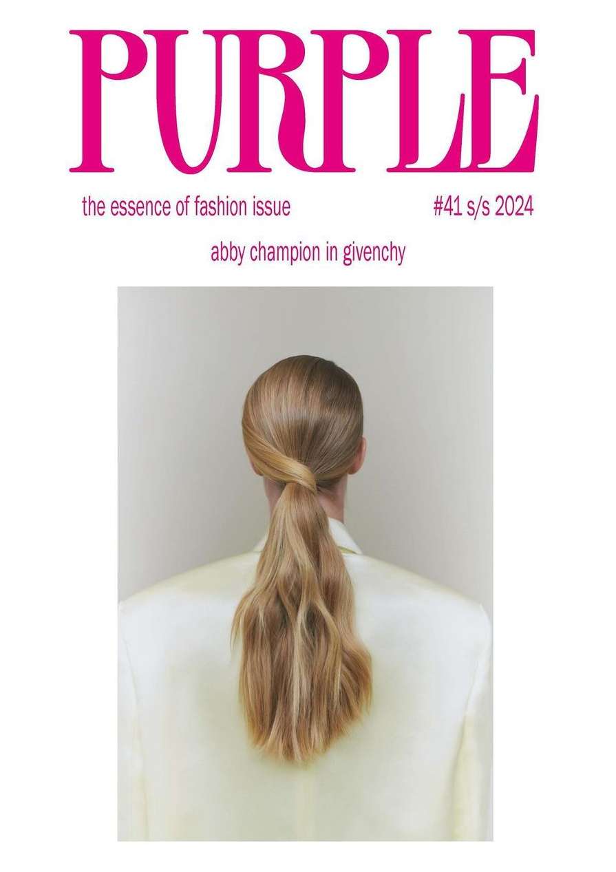 Fashion magazine cover features a blonde woman with a ponytail, seen from behind, wearing a cream-colored jacket against a neutral background.