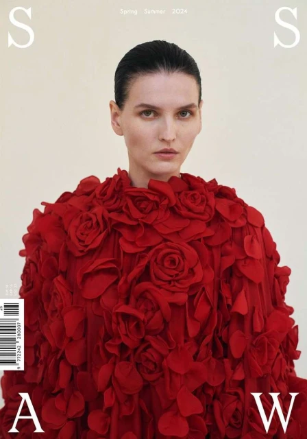 Fashion magazine cover featuring a woman in a red rose dress against a neutral backdrop. Spring/Summer 2024 issue with prominent typography.