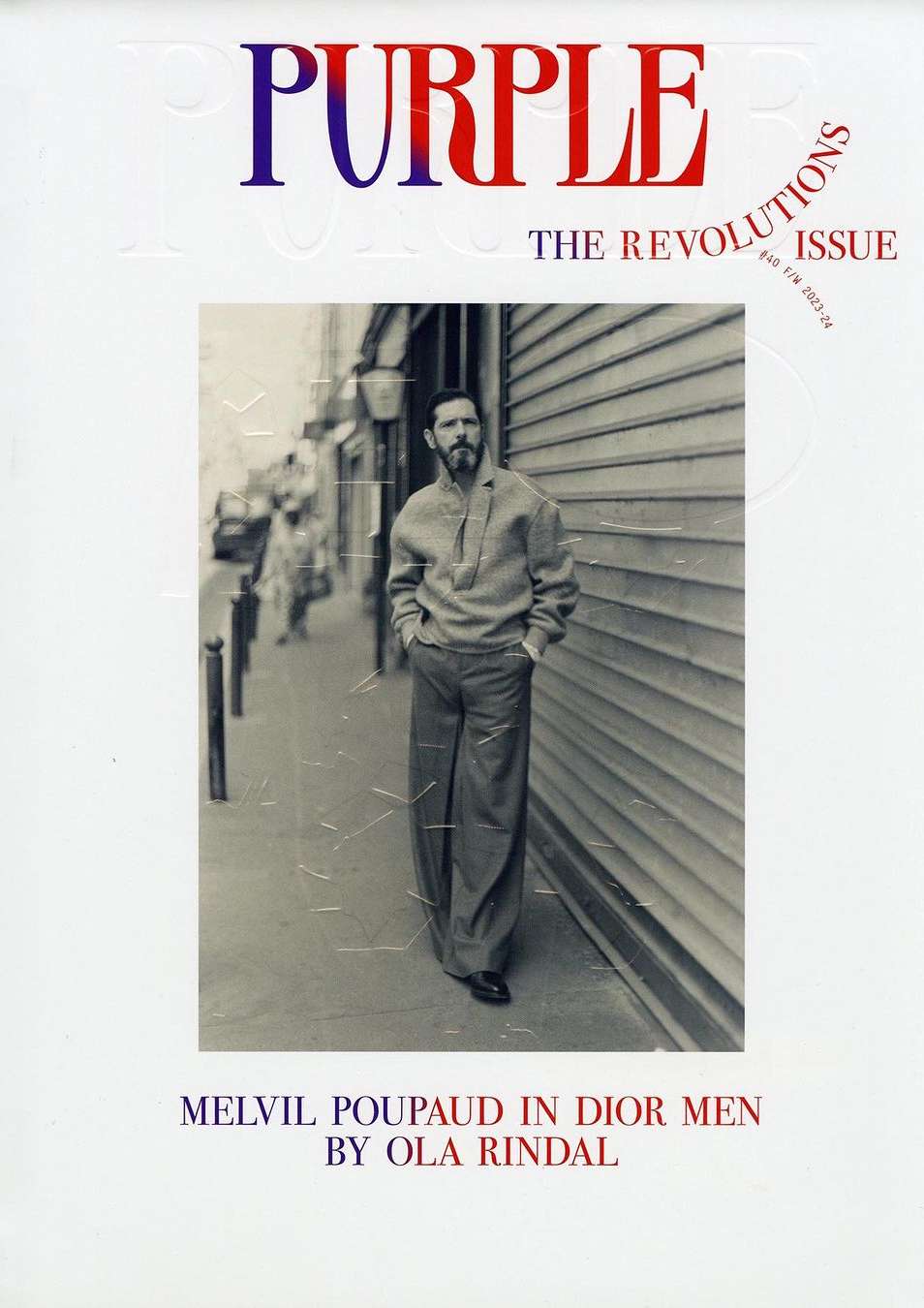 Melvil Poupaud wearing Dior Men standing on a Paris street in a portrait by photographer Ola Rindal for Purple magazine.