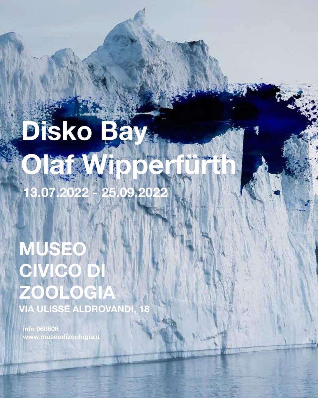 Scenic iceberg landscape under blue sky, evoking a sense of arctic wilderness. Advertisement text in white font for Disko Bay.