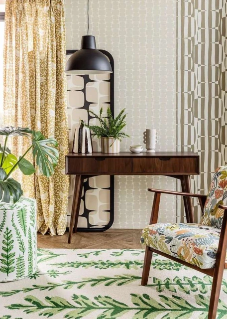 Interior design features a console table with accessories, patterned chair and ottoman, complemented by vibrant botanical-themed rugs and textiles.
