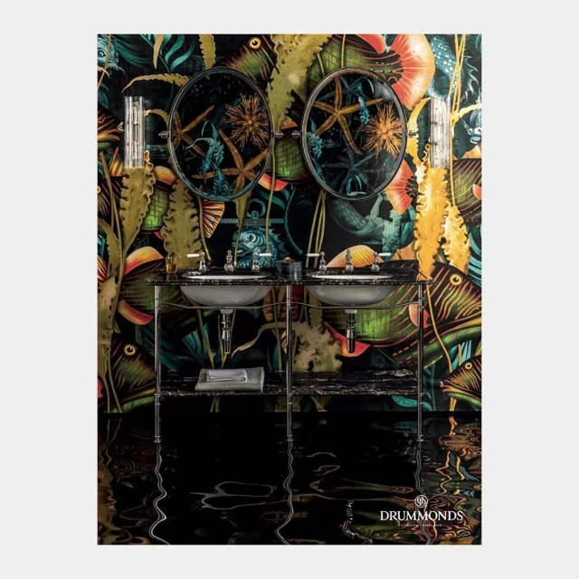 Bathroom interior featuring a double sink vanity with black marble and a patterned wallpaper with an underwater motif and starfish in mirrors.