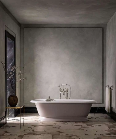 Indoor bathroom scene showcases a freestanding bathtub, marble floors, textured walls, and metal fixtures, evoking a modern aesthetic.