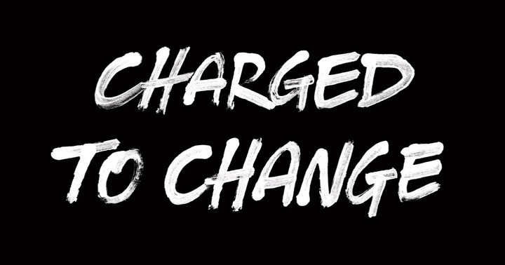 Black background with distressed white text art, 'CHARGED TO CHANGE', creates a bold visual statement with rough edges and texture.