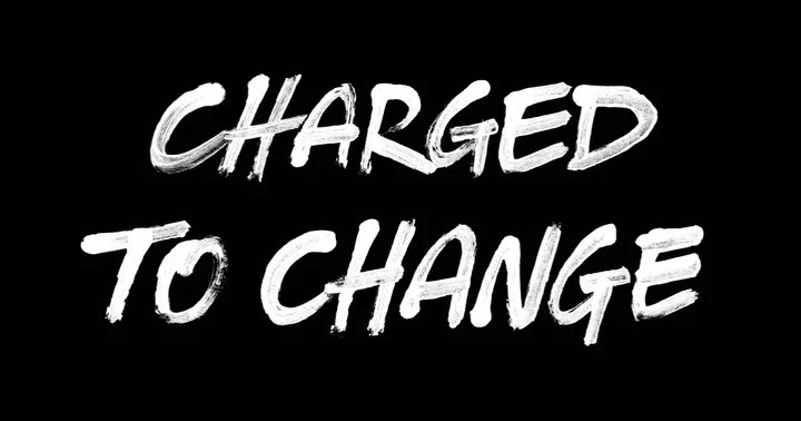 Black background with distressed white text art, 'CHARGED TO CHANGE', creates a bold visual statement with rough edges and texture.