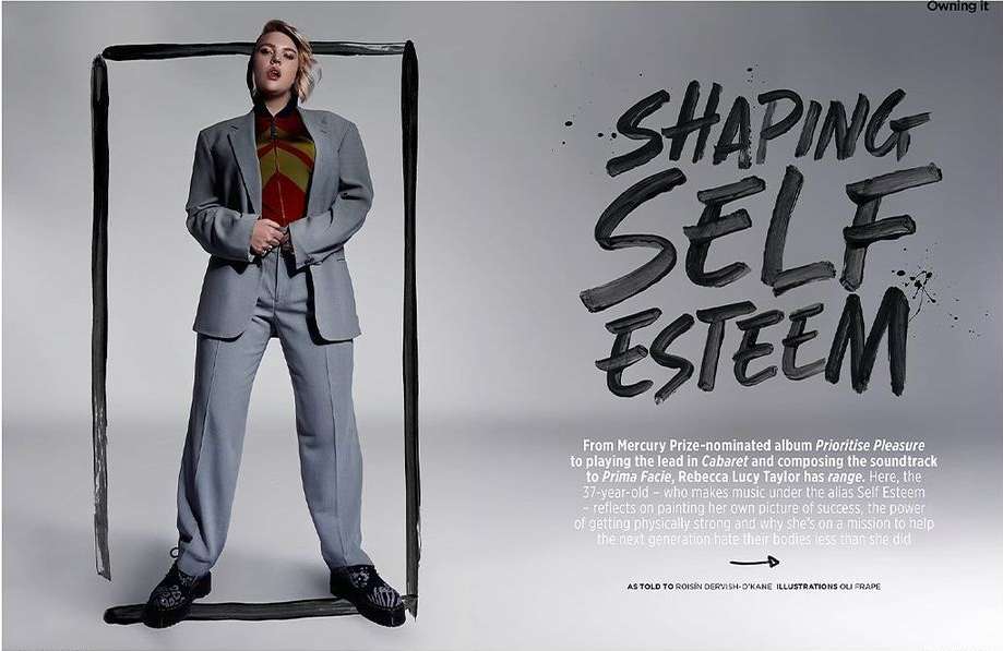 An adult female posing in an oversized grey suit in a studio setting, framed by a thick black paint line, against a light grey backdrop.