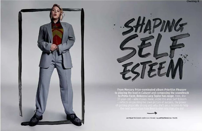 An adult female posing in an oversized grey suit in a studio setting, framed by a thick black paint line, against a light grey backdrop.