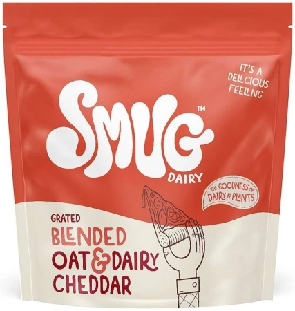 Eye-level view of a Smug Dairy package with a coral background, featuring blended oat and dairy cheddar with a sketch of a hand holding pizza.