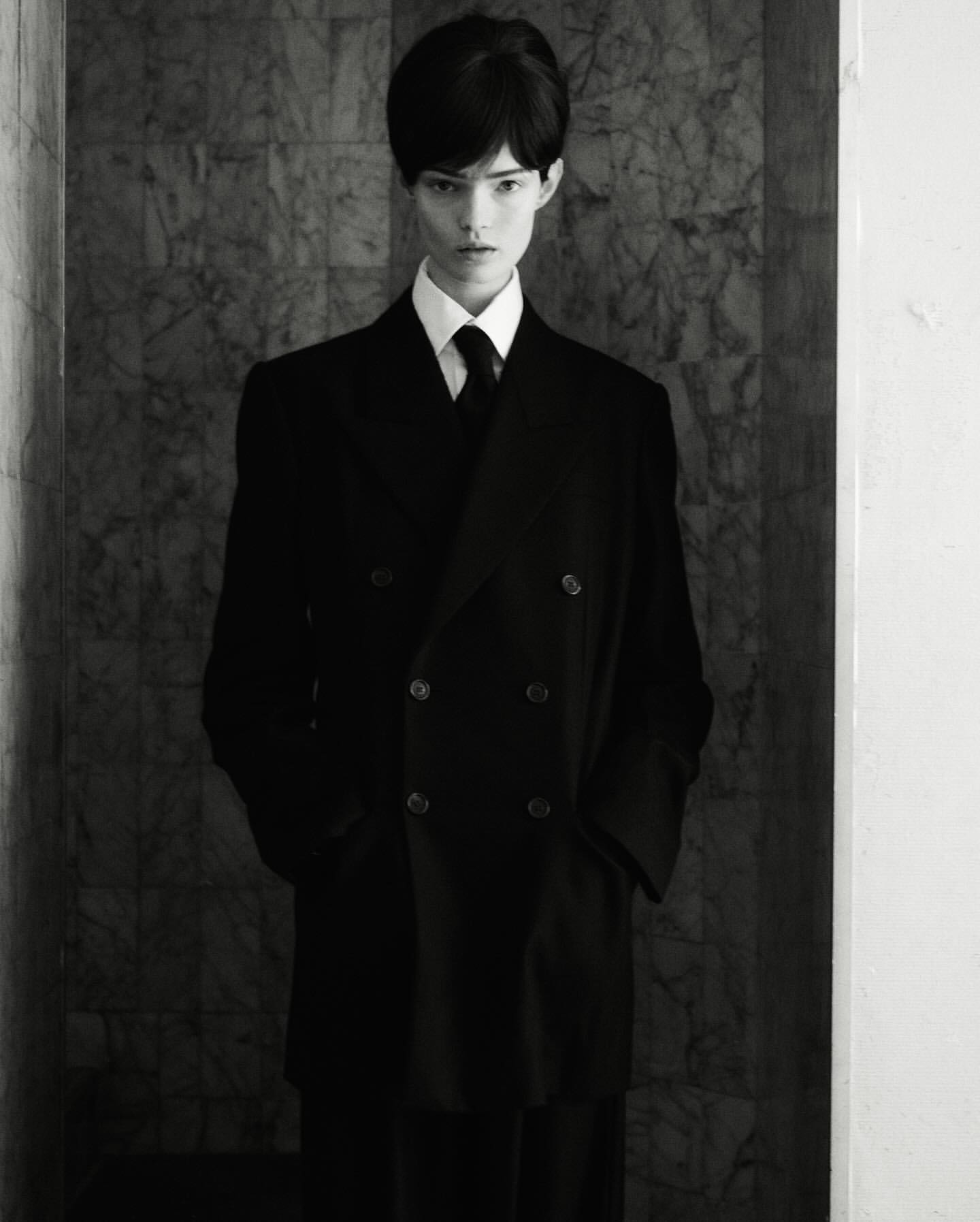 Model in black double breasted coat and tie photographed by Oliver Hadlee Pearch in New York
