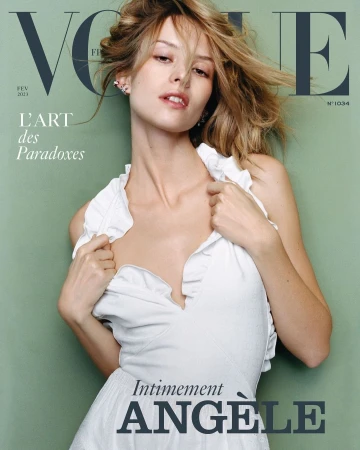 Close-up portrait of a woman in a white ruffled dress against a muted green background, photographed by Oliver Hadlee Pearch.