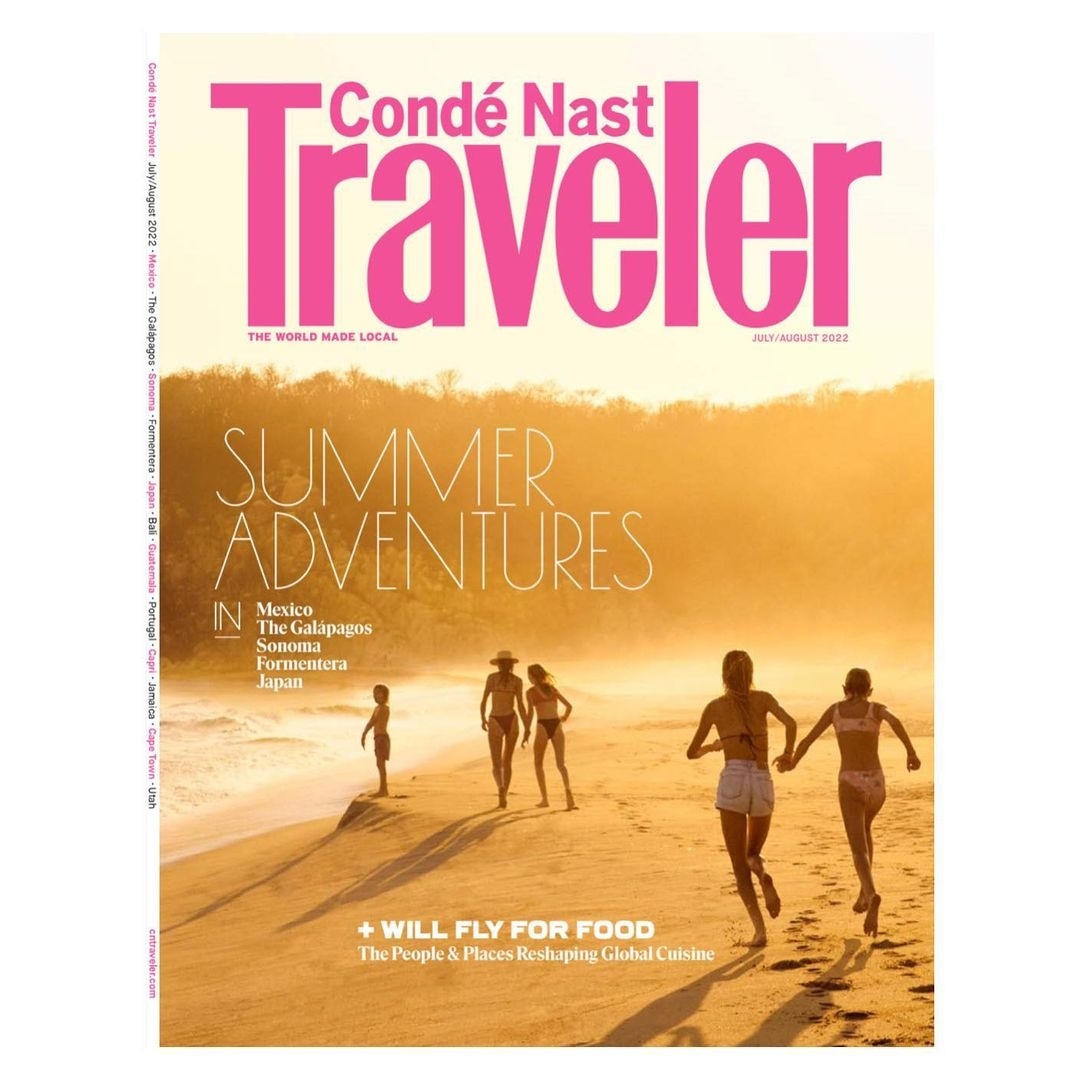 Condé Nast Traveler magazine cover featuring a group of people on a beach during a summer sunset. Text includes 'Summer Adventures'.