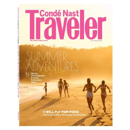 Condé Nast Traveler magazine cover featuring a group of people on a beach during a summer sunset. Text includes 'Summer Adventures'.