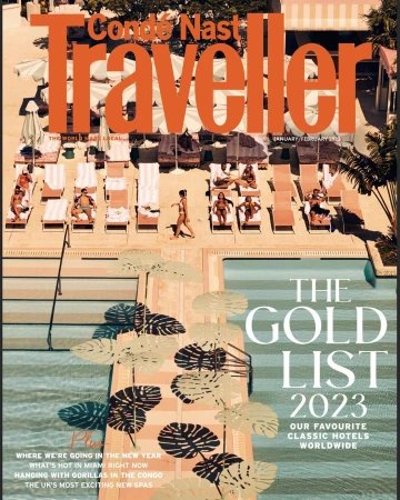 Condé Nast Traveller cover featuring people sunbathing by a pool at a hotel, palm tree shadows, and the magazine's title and cover lines.