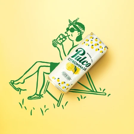 Illustration-style ad featuring a Pulco Citronnade can on a yellow backdrop with a line drawing of a person relaxing in a chair.