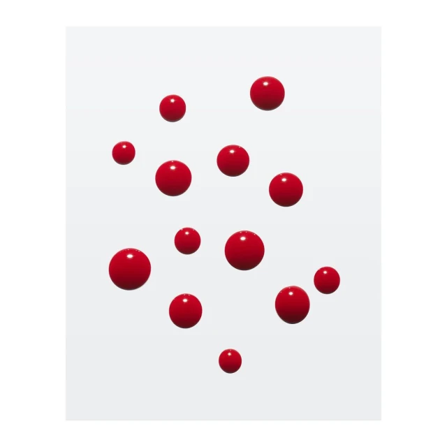 Floating array of red glossy spheres, creating a visually dynamic composition against a soft, diffused white background.