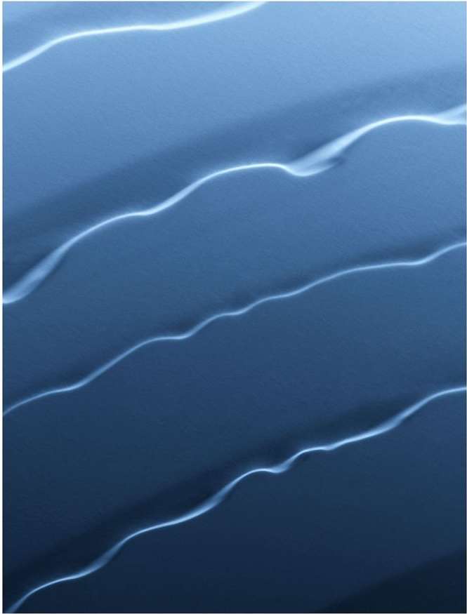 Abstract image featuring wavy, parallel lines in a cool blue palette, reminiscent of flowing water or liquid motion on a monochrome background.