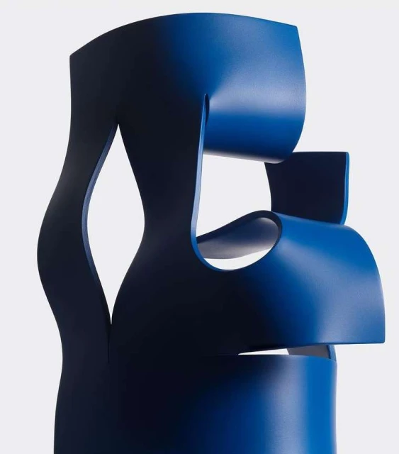 Abstract blue chair sculpture isolated on white. Contemporary furniture design with bold geometric forms and negative space.