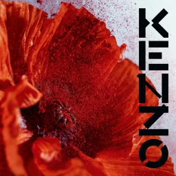 Close up macro shot of a vibrant red poppy flower with scattered red powder against a light background with the word KENZO on the side.