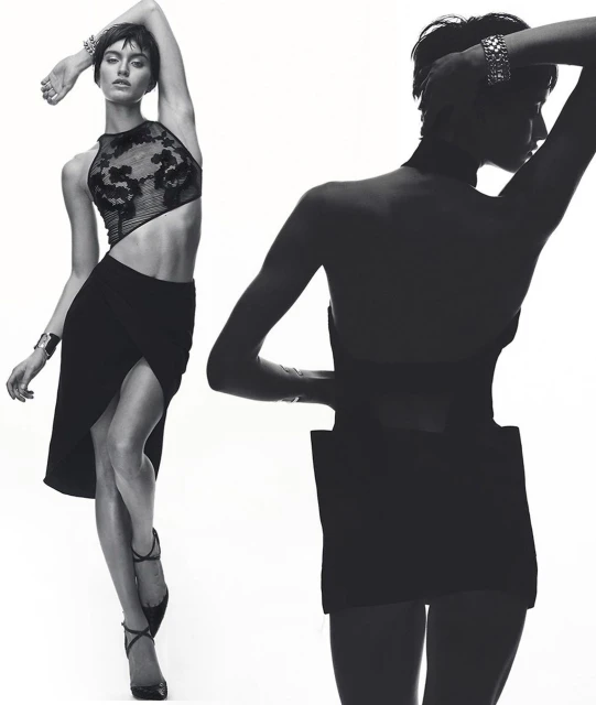 Two fashion models pose in a black and white studio image, wearing a black crop top and a skirt, in a portrait orientation.