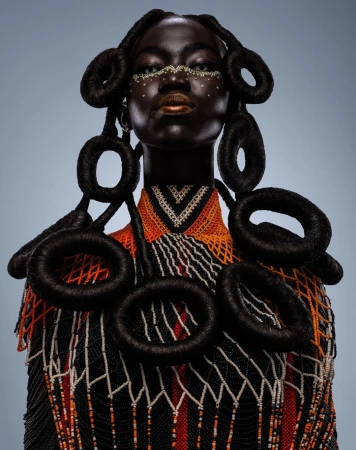 Portrait of a Black woman with sculptural braided hair and beaded collar photographed by Osborne Macharia