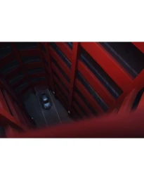 High angle view of a dark car parked inside a multilevel red concrete parking structure