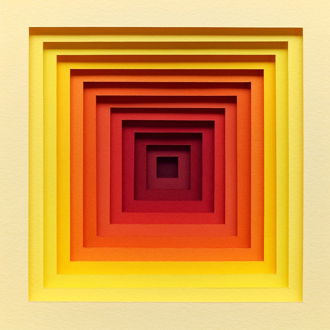 Abstract concentric square art in a warm color gradient from pale yellow to dark red, created with layered paper for a tunnel effect.