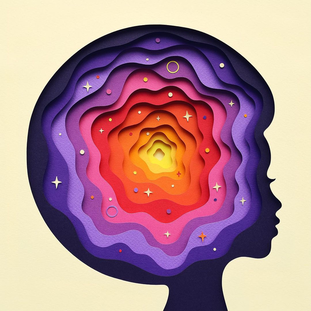 Paper art of a child's head in profile with layers of colorful shapes creating depth, suggesting thought, mind, and inner space.