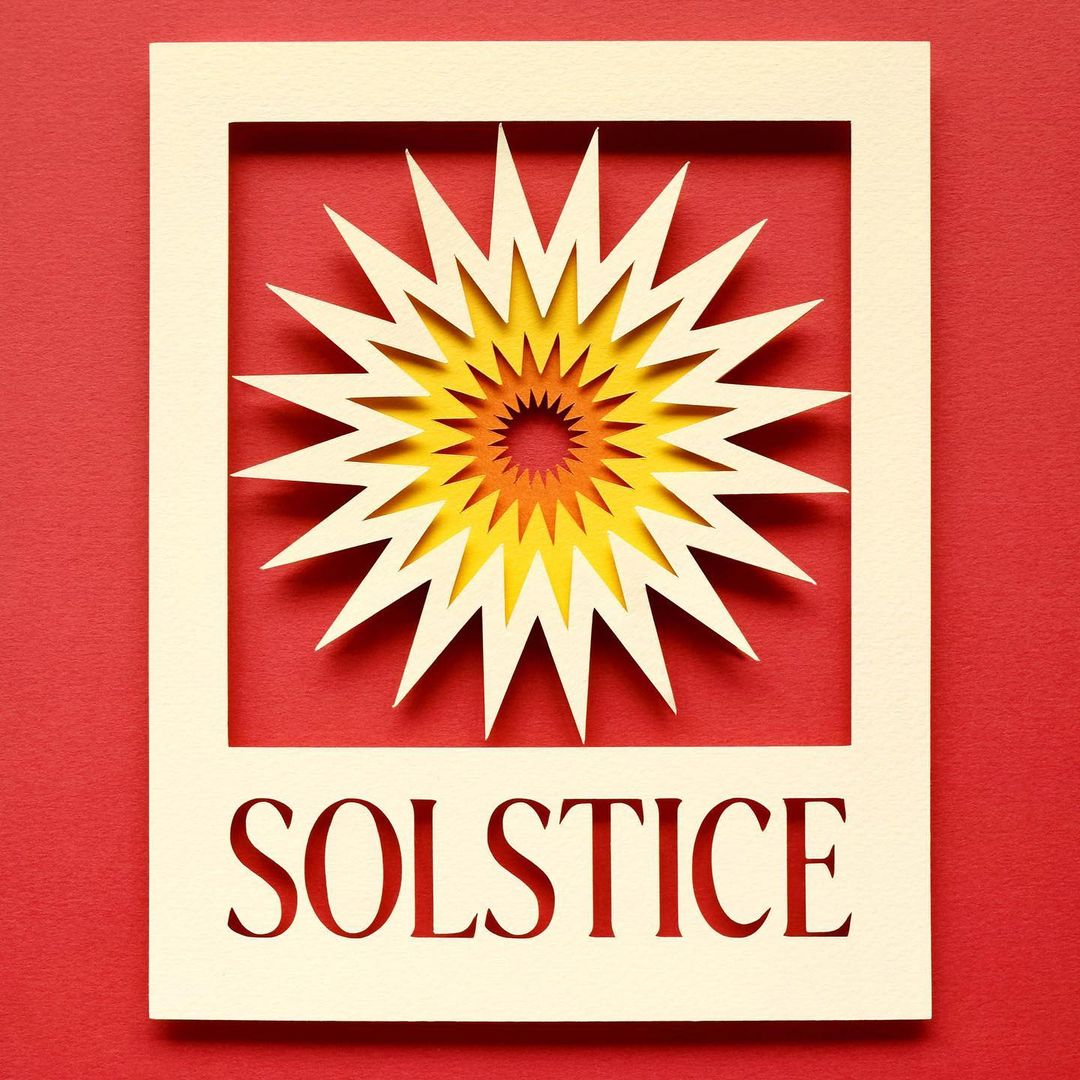 Intricate paper art featuring a multi-layered, sunburst-like design with the word SOLSTICE cut out in a cream-colored frame on red.