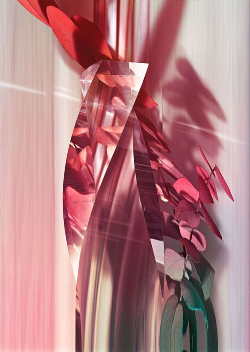 Abstract photo of a glass prism refracting a blurred background featuring red leaves or petals and light streaks in pink tones.