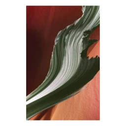Close-up abstract photograph of stacked white and green paper layers creating a wave-like form against a rust-colored background.