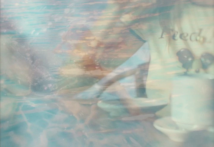 Surreal double exposure featuring an adult female and kitchenware set against a dreamy blue sea background with clouds.