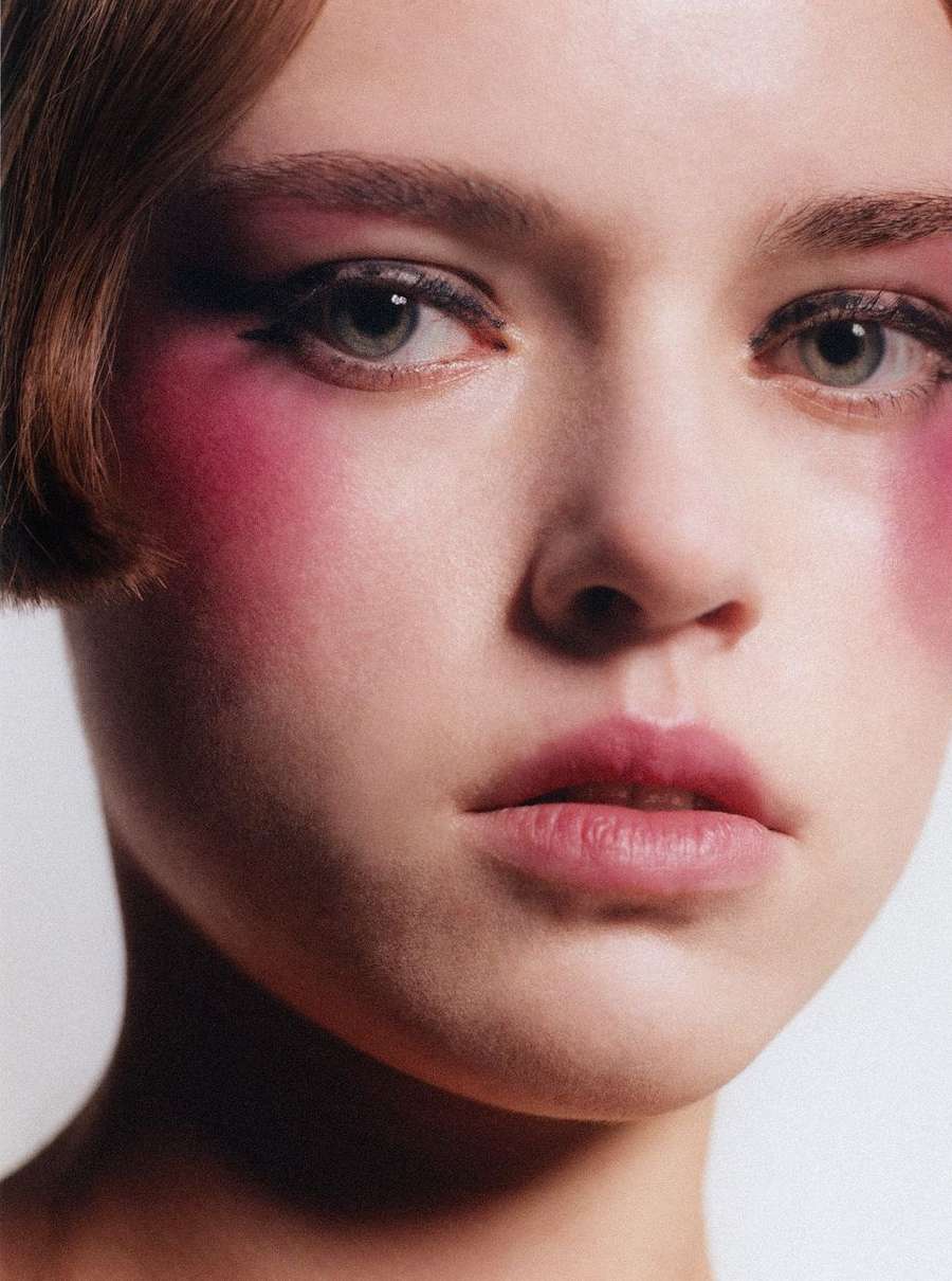 Close-up portrait of a young woman with heavy pink blush and winged eyeliner photographed by Pablo Freda