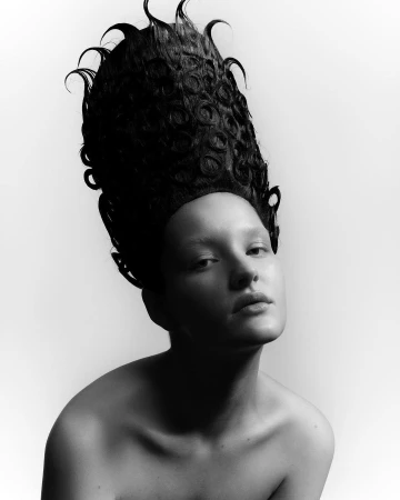 Monochrome portrait of a woman with an elaborate sculptural hairstyle captured by Pablo Freda in Paris.
