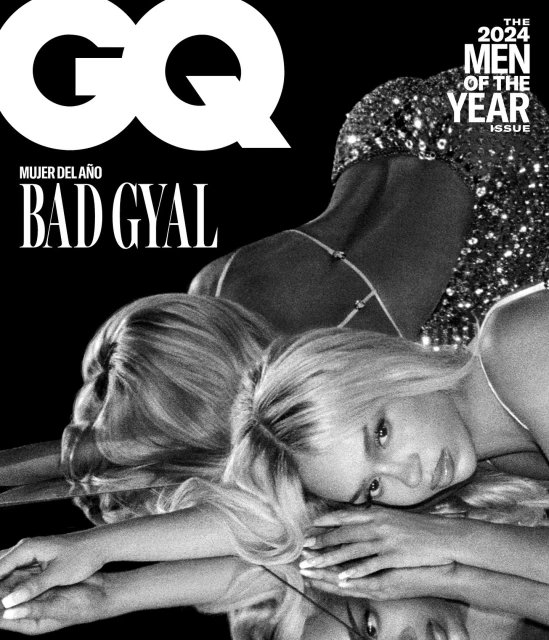 Black and white GQ magazine cover featuring model Bad Gyal in sparkling dress, posing with her reflection on a reflective surface.