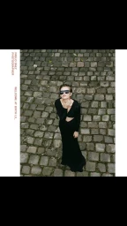 Model wearing dark sunglasses and a black dress on a cobblestone street by photographer Pablo Sáez.
