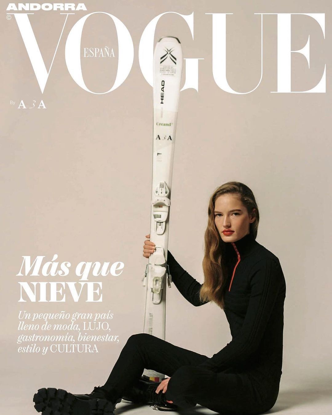 Vogue España cover featuring a woman in black athletic wear holding a pair of skis, in a studio setting with text overlays.